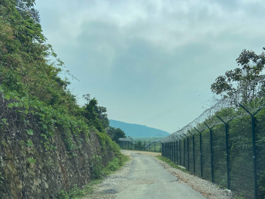 Driving along the barbed wire fence
